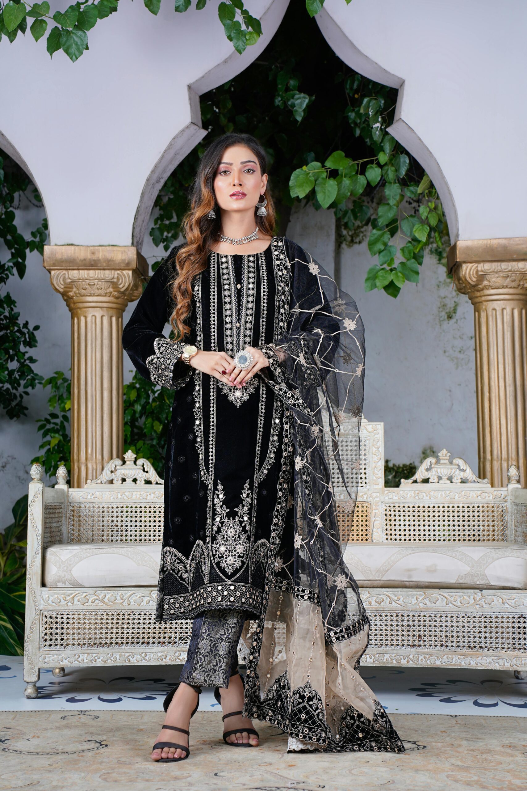 Traditional Pakistani fashion portrait featuring ornate embroidered dress.