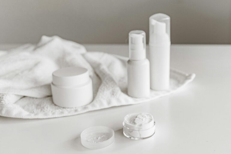 Elegant display of skincare products on a white surface, highlighting simplicity and purity.